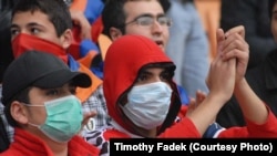 Armenia -- Fans wear medical masks during a soccer match in Yerevan on November 14, 2009.