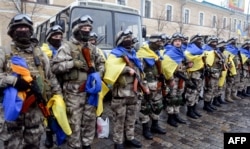 Бійці МВС України із державними прапорами під час церемонії відправки на Донбас у зону збройного протистояння з російськими гібридними силами. Харків, 30 січня 2015 року